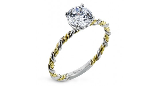 a mixed metal engagement ring with swirling band