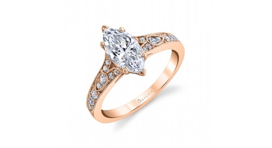 a rose gold engagement ring with a marquise cut center stone