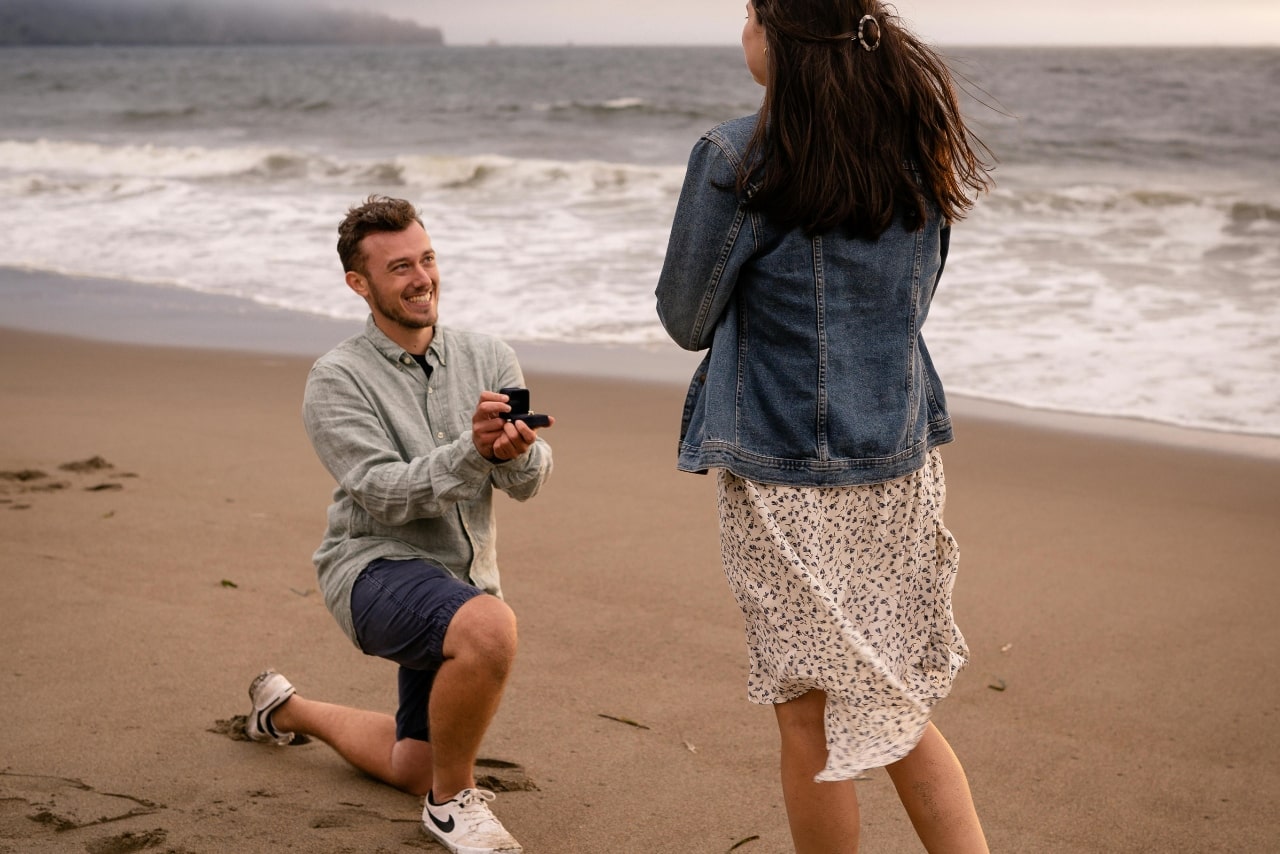 a man proposing to a woman on the beach