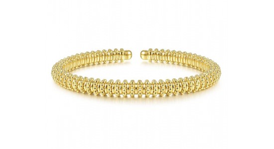 A textured yellow gold cuff bracelet by Gabriel & Co., available at Drenon Jewelry.