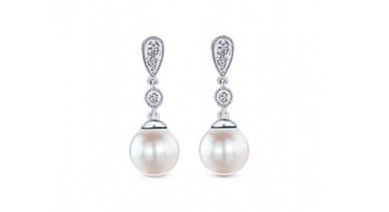a pair of pearl drop earrings with diamond accents