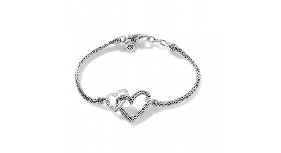 a chain bracelet by John Hardy with two heart motifs