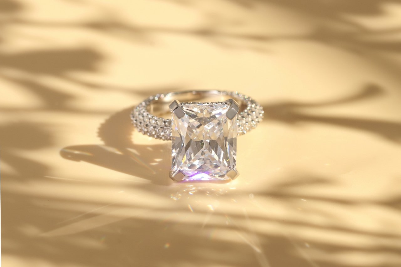 a sparkling diamond engagement ring on a light background