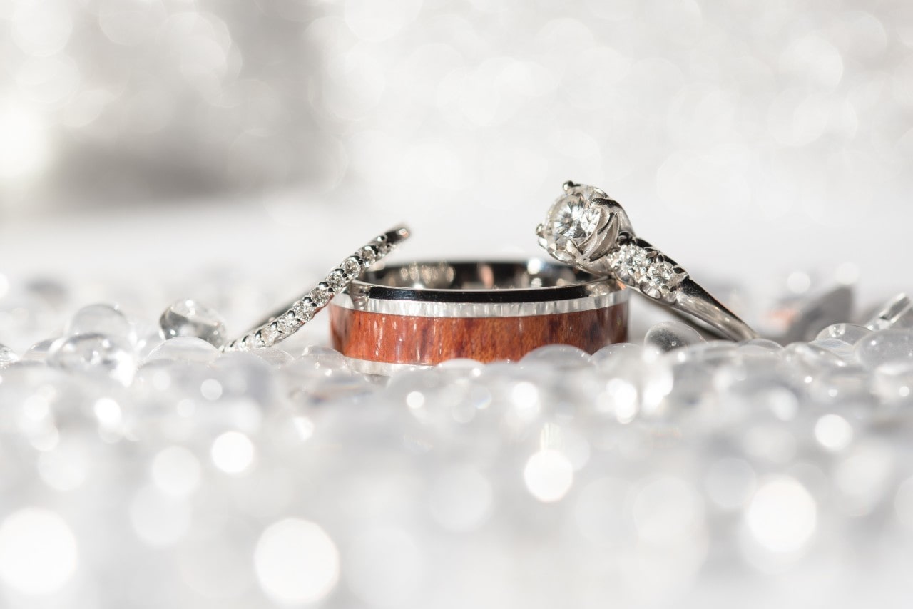 A diamond-accented engagement rings with a wedding band surrounded by crystals